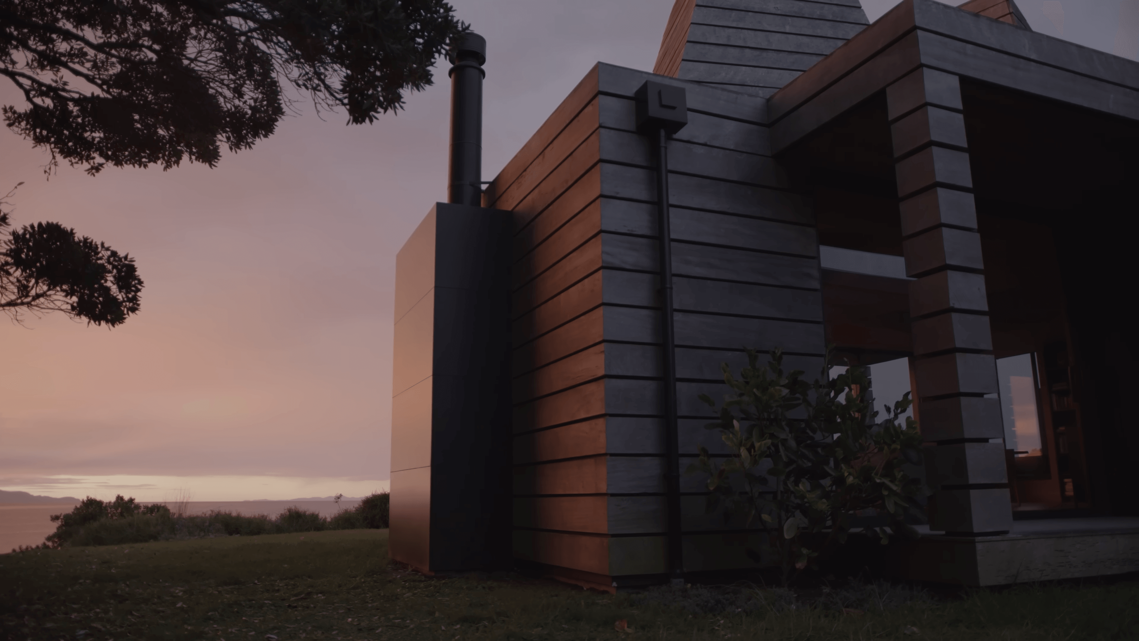 The Kilns — exterior cladding and flue detail at sunset