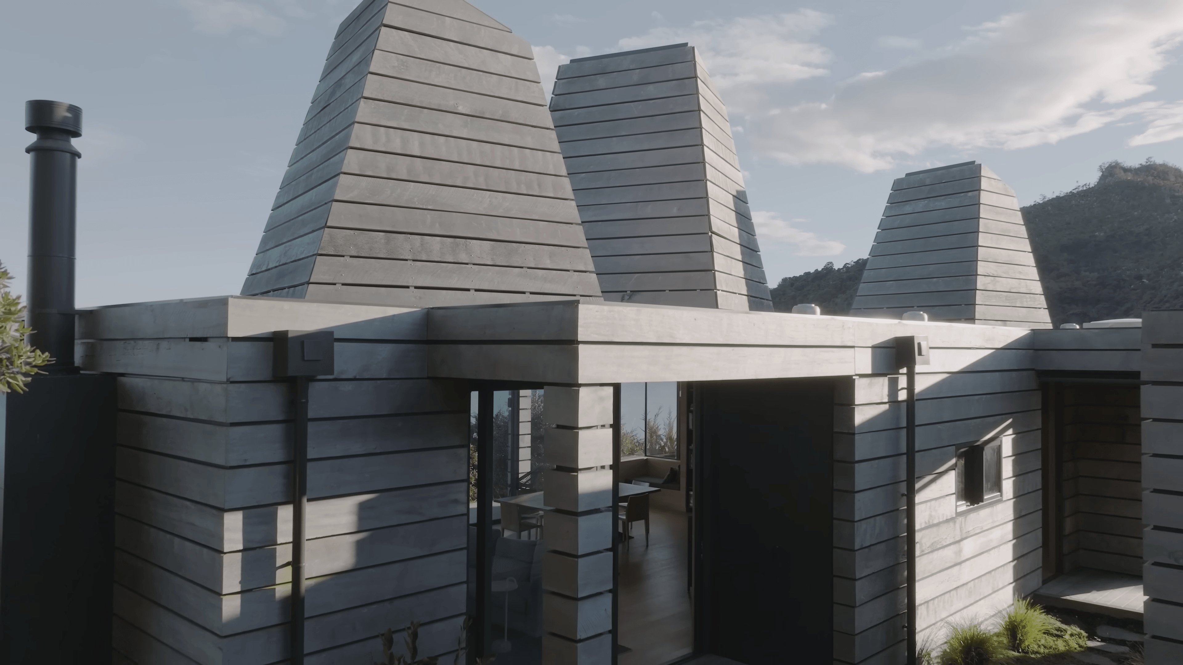 The Kilns — tapered tower roofs against a clear sky, daytime